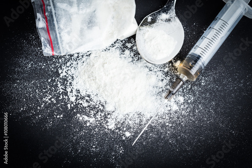 Photos Drug syringe and cooked heroin on spoon