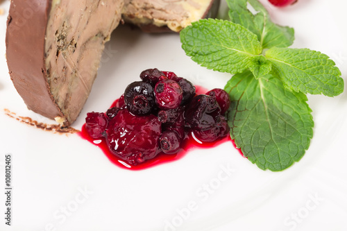 Delicious foie gras covered with dark chocolate. photo