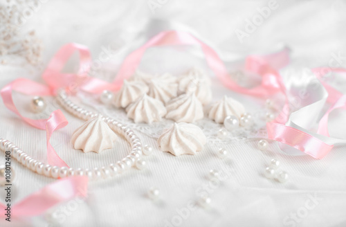 Fototapeta Naklejka Na Ścianę i Meble -  French meringue cookies for wedding background with pearls, pink and white satin ribbons and lace, close-up