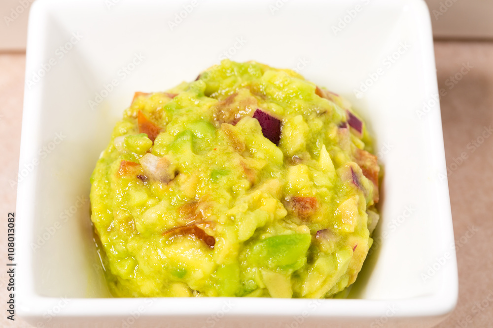 Delicious guacamole dip in white bowl. Delicious guacamole dip in white bowl.