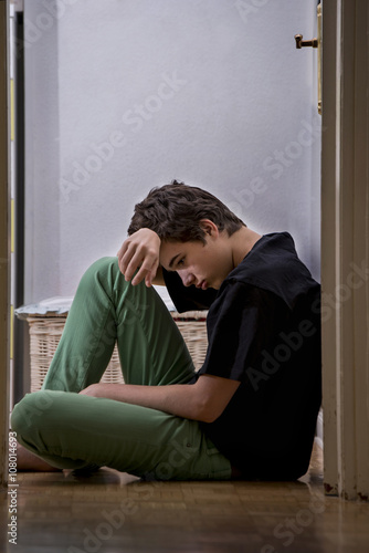 Young, he is sitting on the floor, looking worried