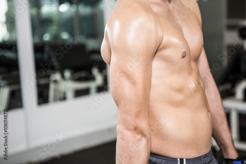 Shirtless muscular man showing arm