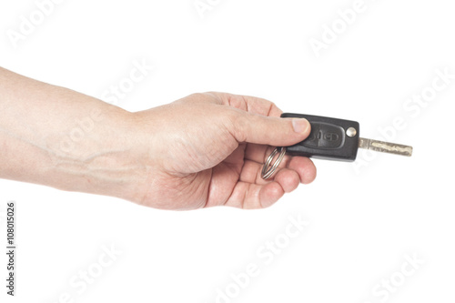 Hand with a car key isolated on white background