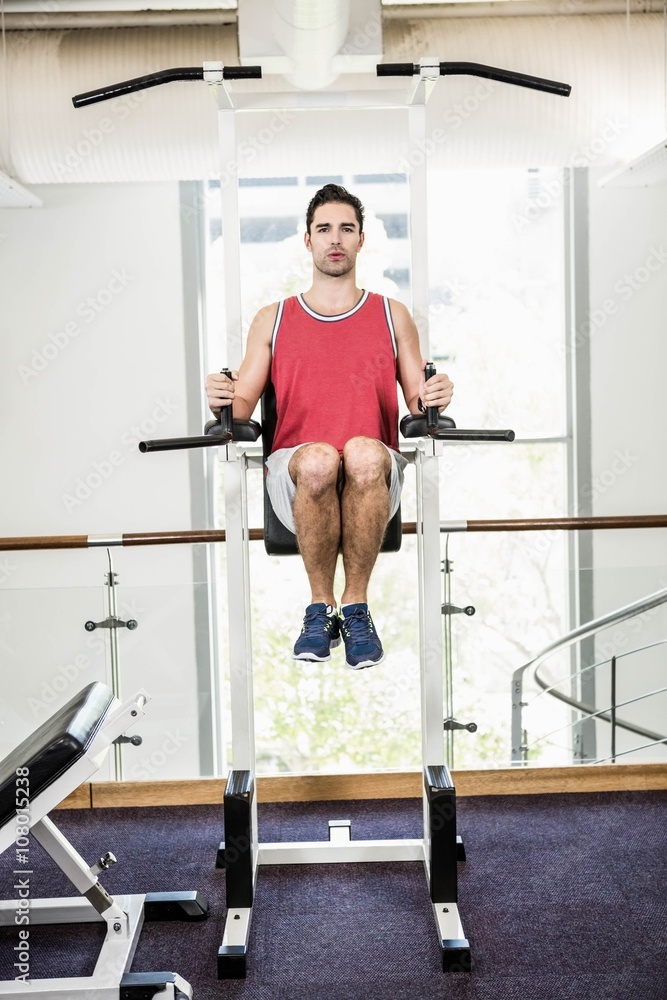 Fototapeta premium Muscular man doing pull up