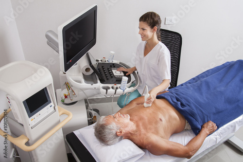 Woman doctor analyzing patient with ultrasound photo