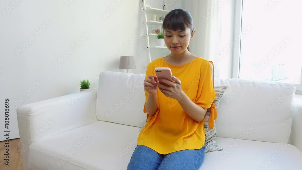 happy asian woman with smartphone at home happy asian woman with smartphone at home