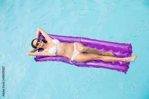 Beautiful woman relaxing on inflatable raft 