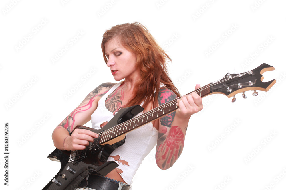 Fototapeta premium Attractive redhead punk girl with tattoos playing electrical guitar