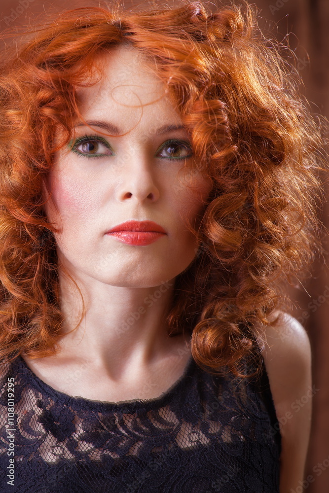 Fototapeta premium Portrait of beautiful woman with long curly red.