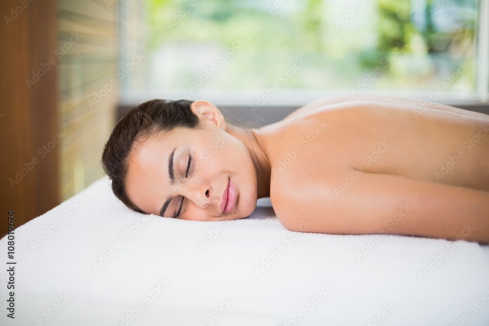 Attractive young woman relaxing on massage table Attractive young woman relaxing on massage table