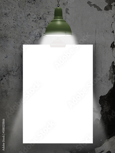 Close-up of one blank frame hanged by clip with lamp against dark cracked wall background