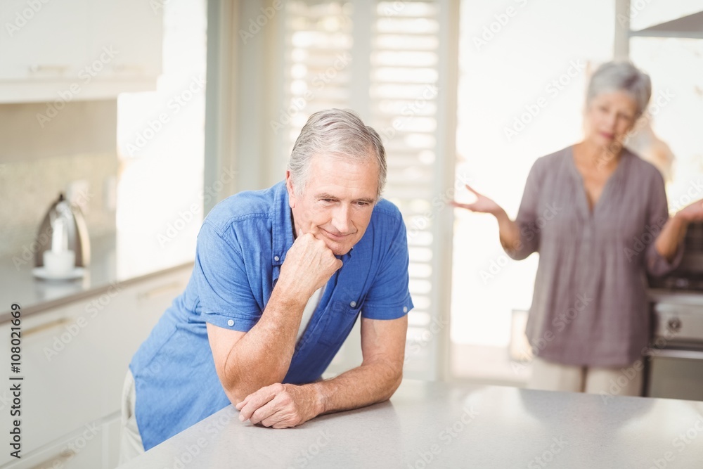 Fototapeta premium Senior man with woman arguing in background