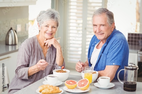 Portrait of smiling senior couple having breakfast