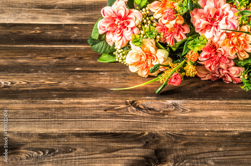 Mixed flowers bouquet on wood background.