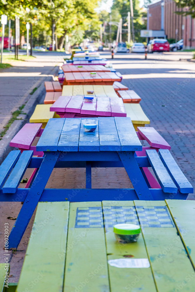 Line of Colorful Picnic Tables Line of Colorful Picnic Tables