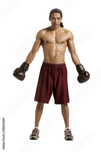 well built male boxer wearing brown boxing gloves