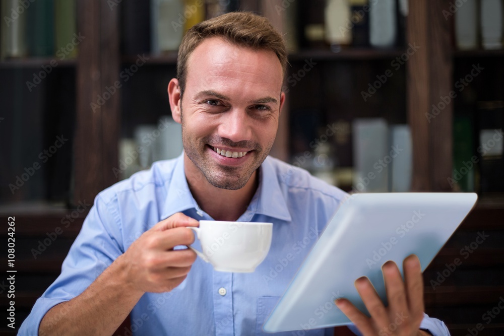 Portrait of businessman using digital tablet while having coffee Portrait of businessman using digital tablet while having coffee