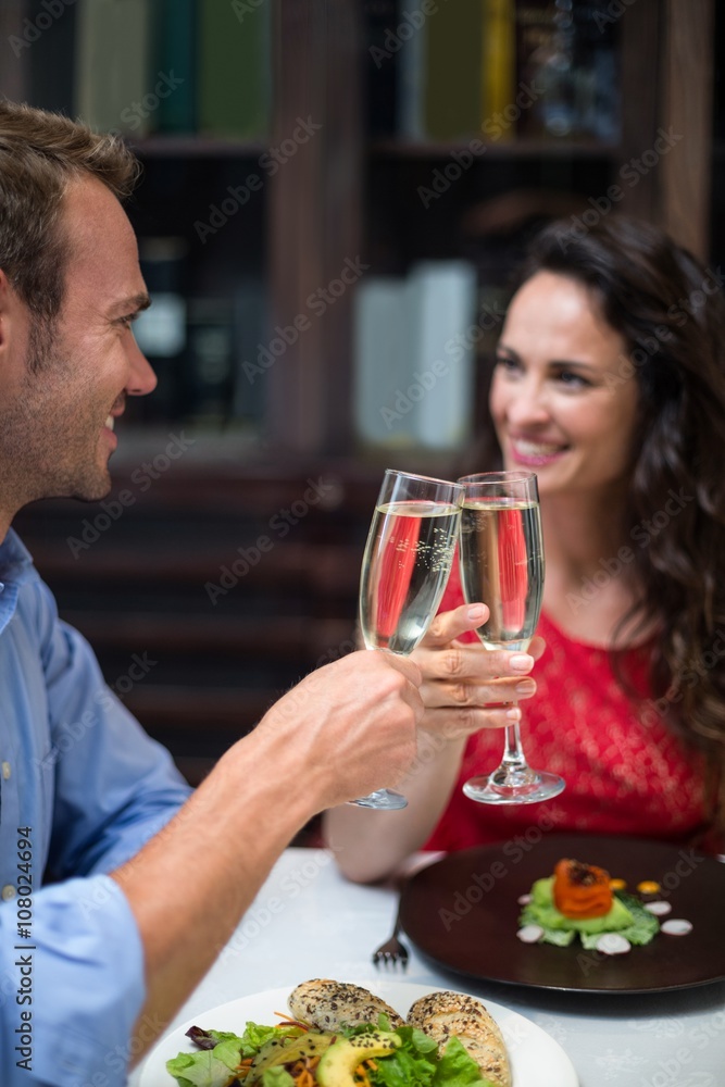 Happy couple holding champagne flutes