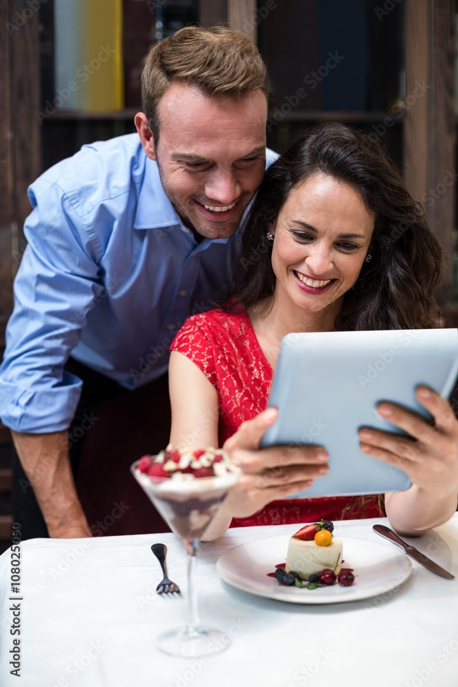 Happy couple using digital tablet Happy couple using digital tablet
