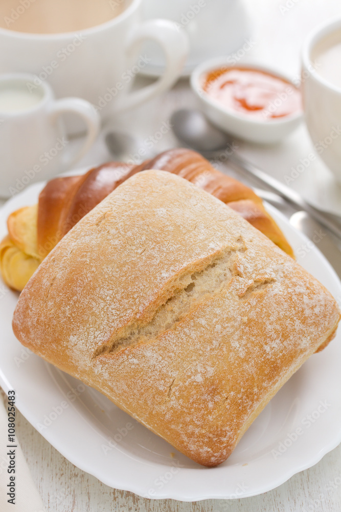 bread with coffee on white wooden background bread with coffee on white wooden background
