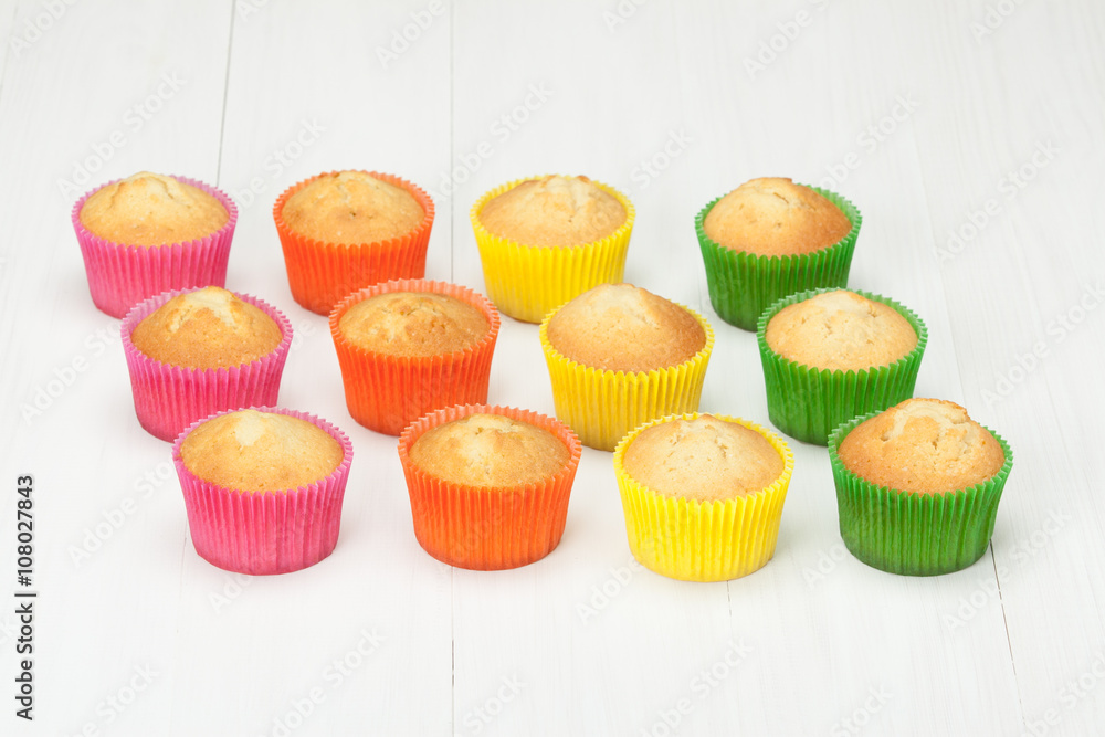 Homemade Colorful Plain Cupcakes On White Table. Homemade Colorful Plain Cupcakes On White Table.