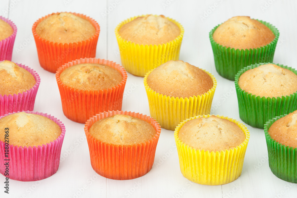 Homemade Colorful Plain Cupcakes On White Table. Homemade Colorful Plain Cupcakes On White Table.