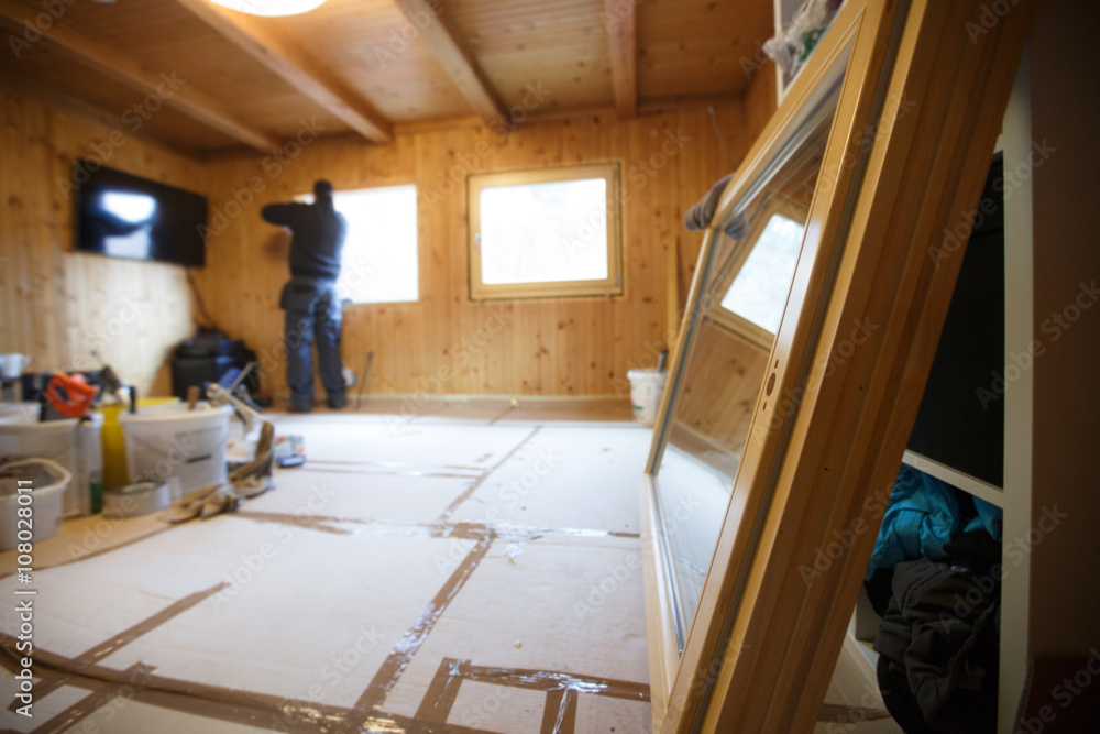 Worker installing new wooden windows