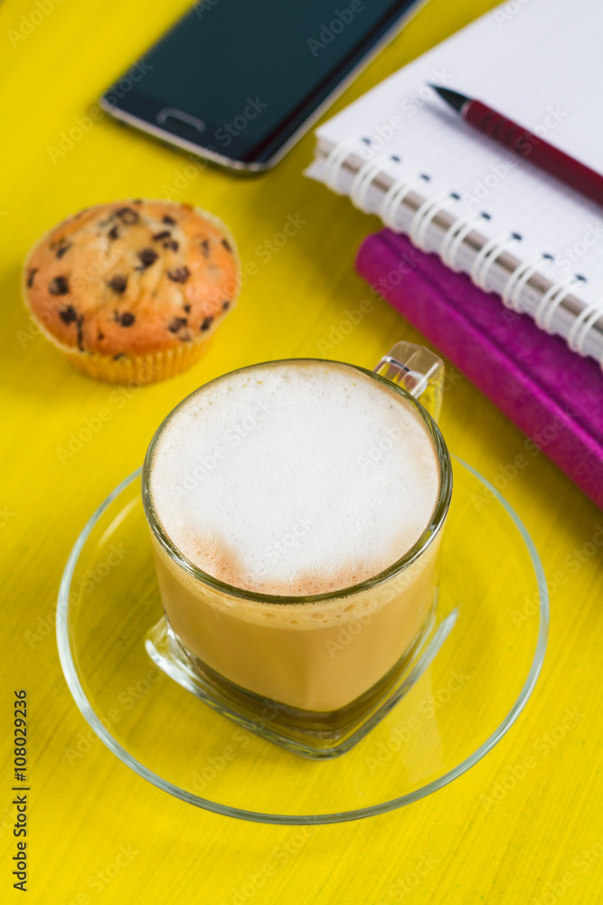 Cup of coffee, notebook and smart phone on a table Cup of coffee, notebook and smart phone on a table