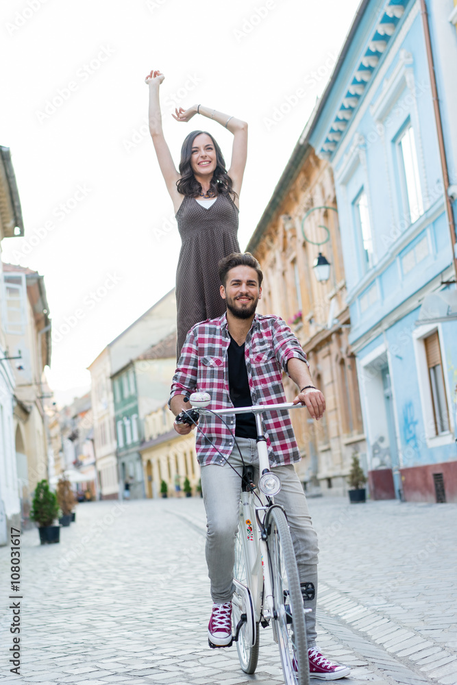 Fototapeta premium happy couple riding a white bike