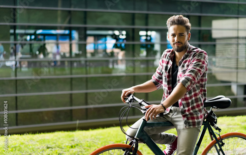 Handsome young man with his retro bike photo