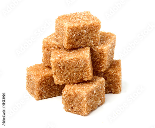 Brown cane sugar cubes isolated.