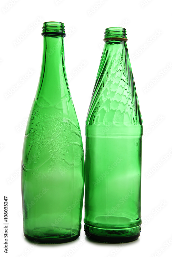 Green bottles and glasses on a white background Green bottles and glasses on a white background