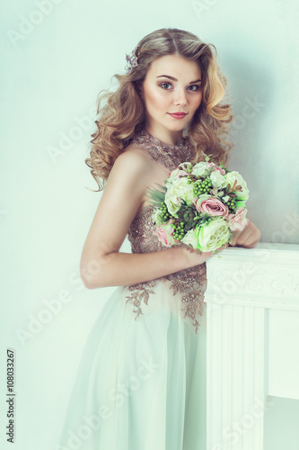 Beautiful bride in wedding dress. Portrait of young bride. Studio shot.
