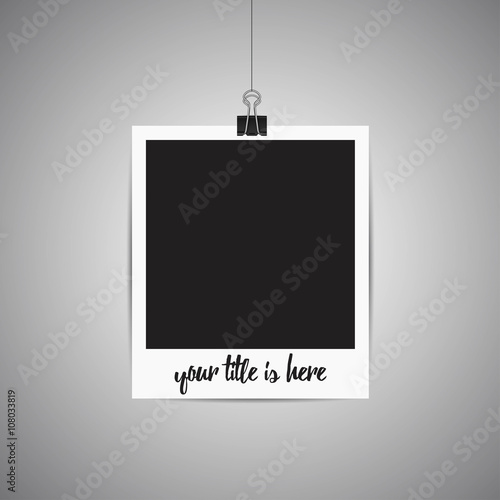 Polaroid picture hanging on the wall. Picture frame on gray. Pla