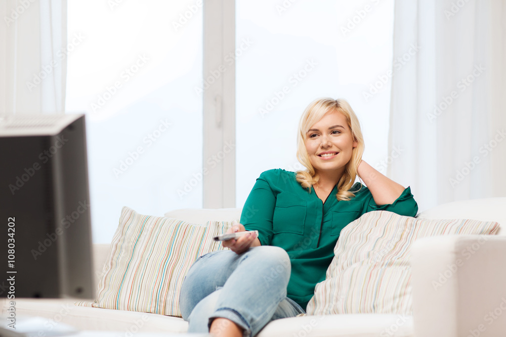 smiling woman with remote watching tv at home smiling woman with remote watching tv at home