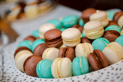 White, green and brown macarons with side light