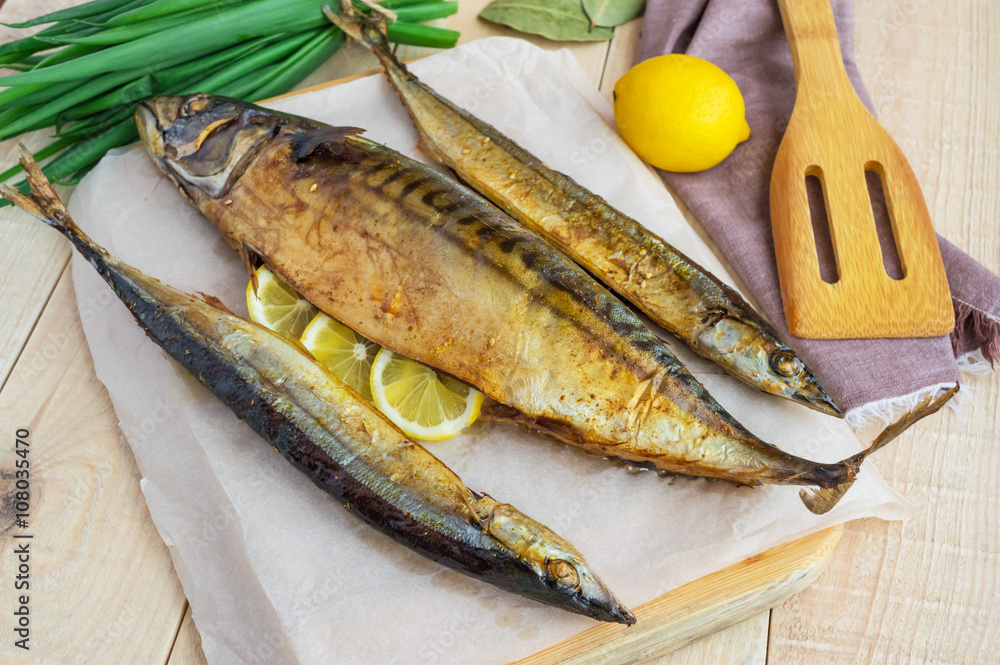 Baked sea fish (saury, mackerel) on wooden background. Baked sea fish (saury, mackerel) on wooden background.