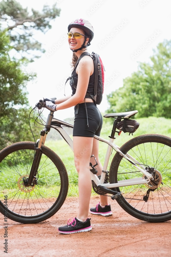 Naklejka premium Woman standing with her bike