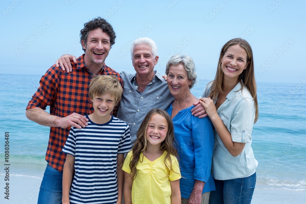 Cheerful multi-generation family standing at sea shore Cheerful multi-generation family standing at sea shore