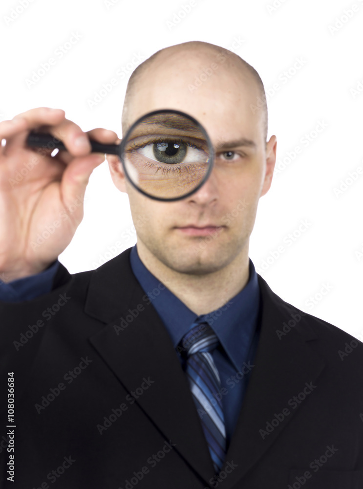 view of a man looking through magnifying glass. view of a man looking through magnifying glass.