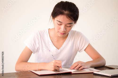 asia thai china student university beautiful girl write a book.