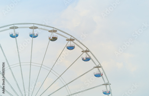 ferris wheel against sky and clouds