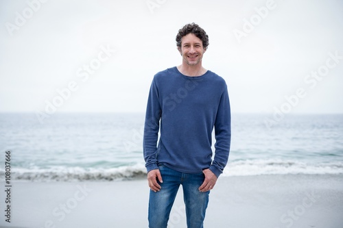 Confident man smiling while standing at sea shore © WavebreakMediaMicro
