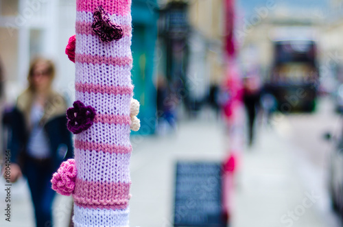 Yarn bombing in Bath, Somerset, UK.  An organised group cover poles and posts with knitting, using wool to brighten up Milsom Street in the city centre photo