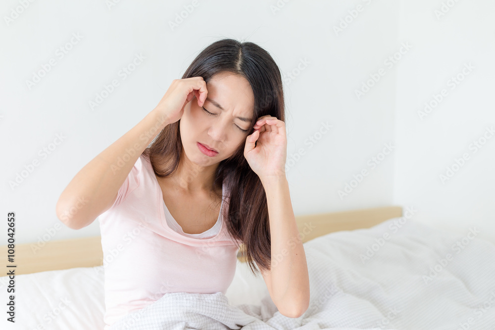 Woman suffer from headache and resting on bed Woman suffer from headache and resting on bed