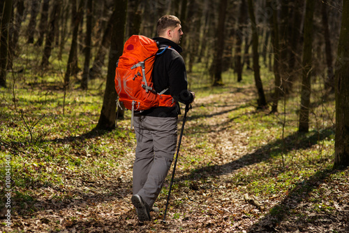 Male hiker looking to the side walking in forest