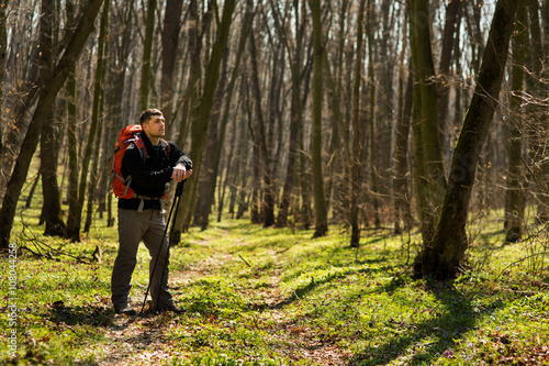 Wallpaper Mural Male hiker looking to the side walking in forest Torontodigital.ca