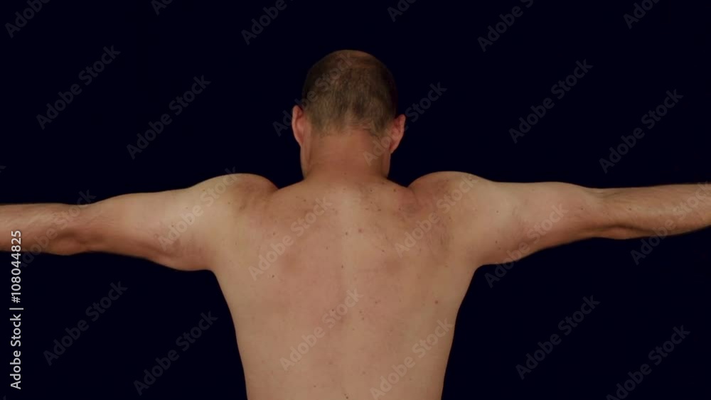 Back view of a naked man showing his muscles, studio isolated. Back view of a naked man showing his muscles, studio isolated.