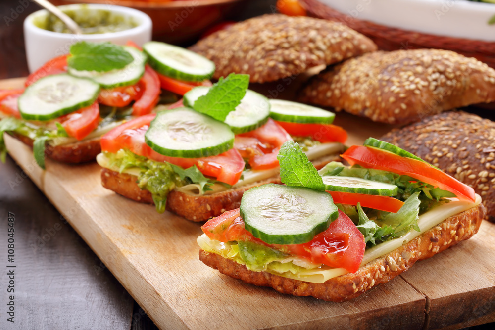 Vegetarian sandwich with pesto on wooden background Vegetarian sandwich with pesto on wooden background