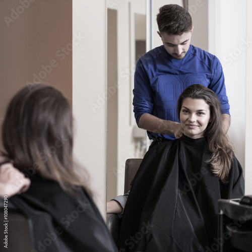 Male hairdresser and attractive woman